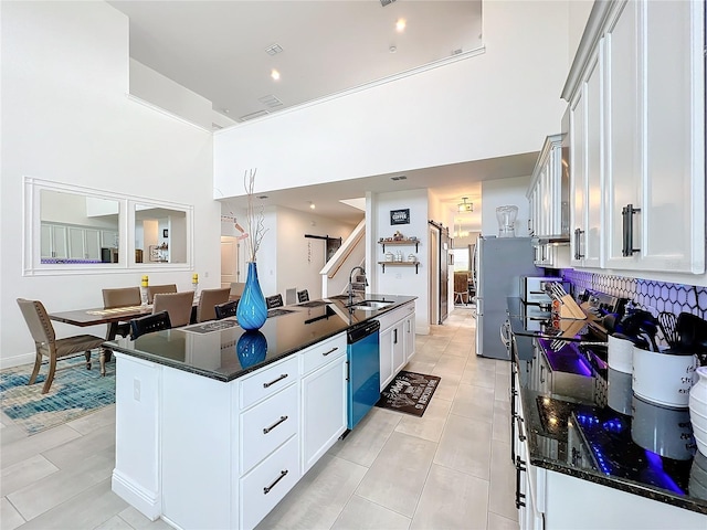 kitchen featuring dishwasher, white cabinetry, stainless steel refrigerator, and sink