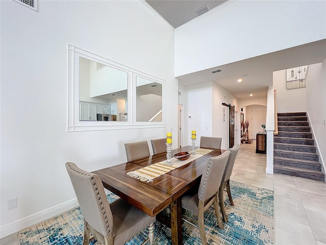 tiled dining room featuring a high ceiling