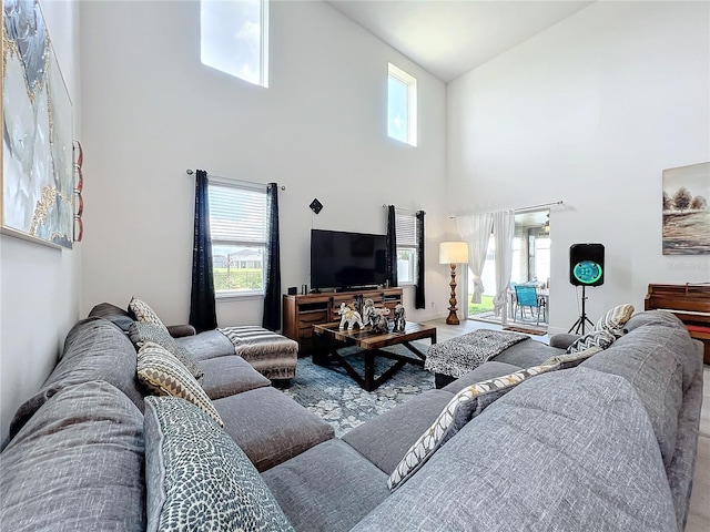 living room with high vaulted ceiling