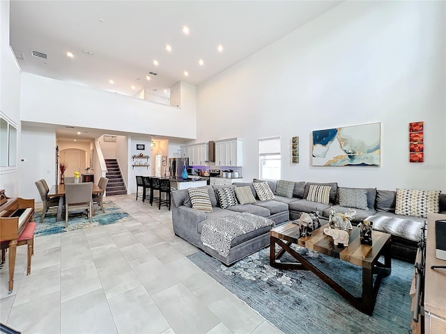 living room featuring a towering ceiling