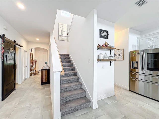 stairway featuring a barn door