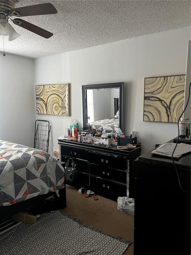 carpeted bedroom with a textured ceiling and ceiling fan