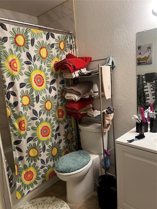 bathroom with vanity, toilet, a shower with shower curtain, and tile patterned flooring