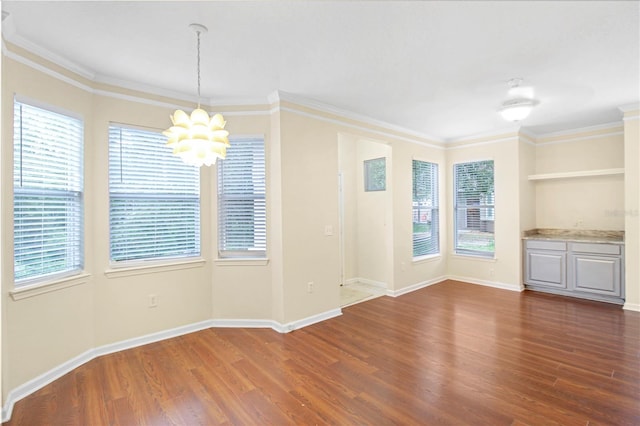 interior space with a wealth of natural light, a notable chandelier, and dark hardwood / wood-style flooring