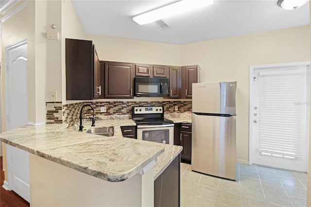 kitchen with dark brown cabinetry, appliances with stainless steel finishes, kitchen peninsula, and sink