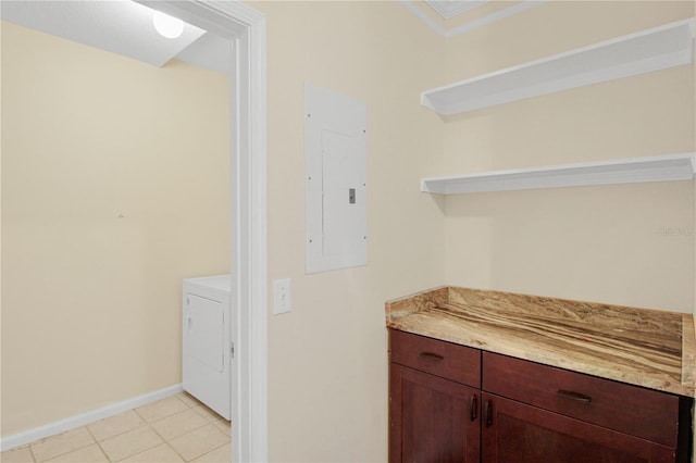 bar with washer / clothes dryer, light tile patterned floors, electric panel, and ornamental molding