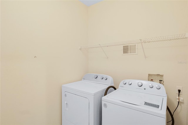 laundry area with independent washer and dryer