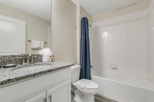 full bathroom featuring a textured ceiling, vanity, toilet, hardwood / wood-style flooring, and shower / bath combo