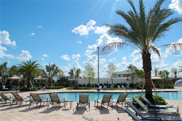 view of swimming pool with a patio area and pool water feature