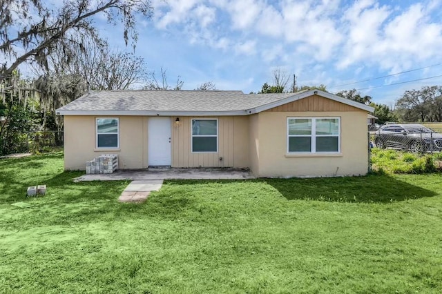 rear view of house featuring a patio and a yard