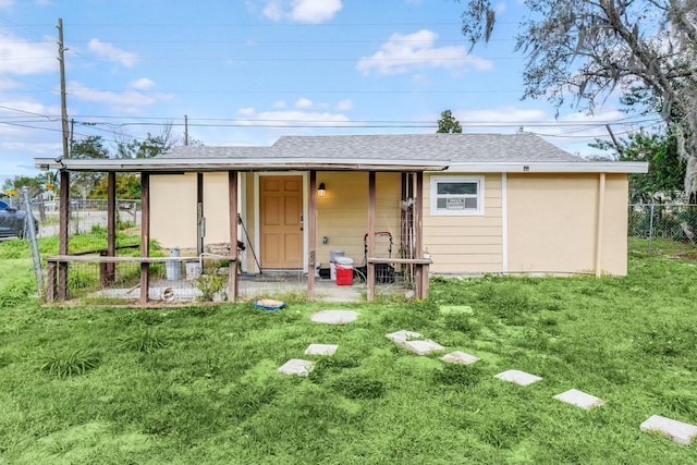 5351 E Johnson Ave, Haines City, FL 33844 - rear view of house with fence, a yard, and roof with shingles