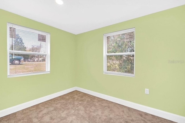 carpeted empty room with a wealth of natural light