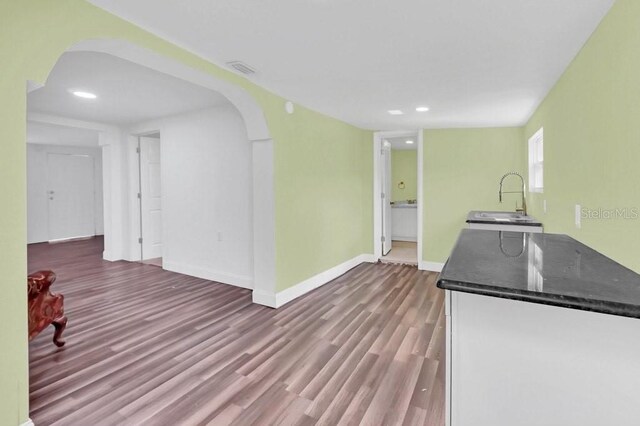 5351 E Johnson Ave, Haines City, FL 33844 - kitchen featuring recessed lighting, arched walkways, wood finished floors, and baseboards