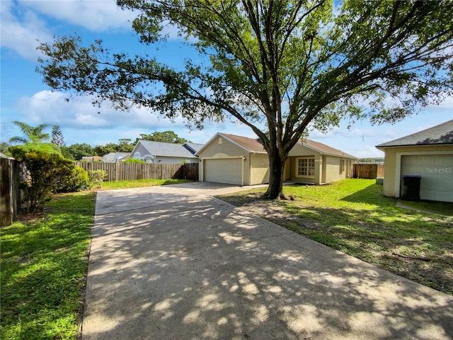 single story home with a garage and a front lawn