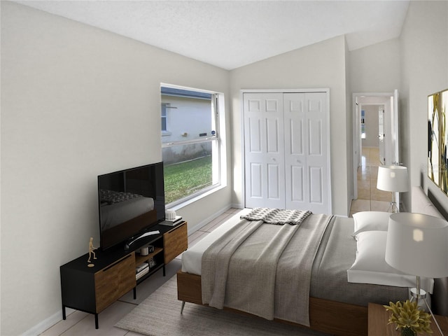 bedroom with lofted ceiling, a closet, and a textured ceiling