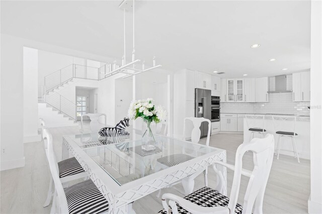 dining area featuring a chandelier and light hardwood / wood-style floors