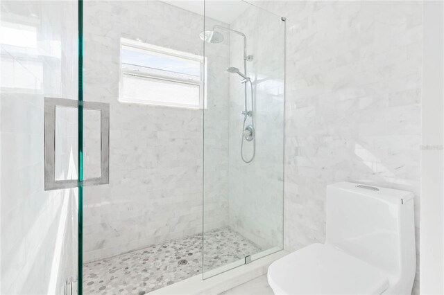 bathroom featuring tile walls, toilet, and an enclosed shower