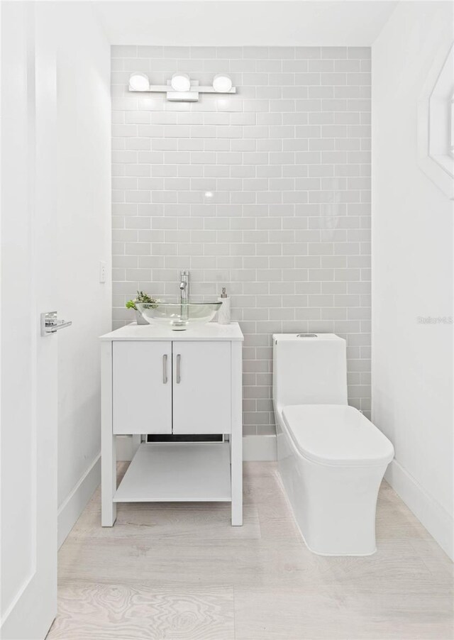 bathroom with vanity, hardwood / wood-style floors, and toilet