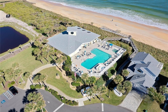 drone / aerial view featuring a water view and a beach view