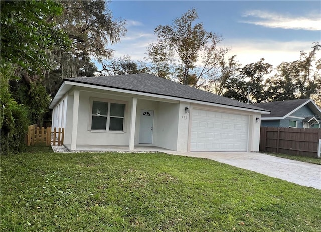 ranch-style home featuring a yard and a garage