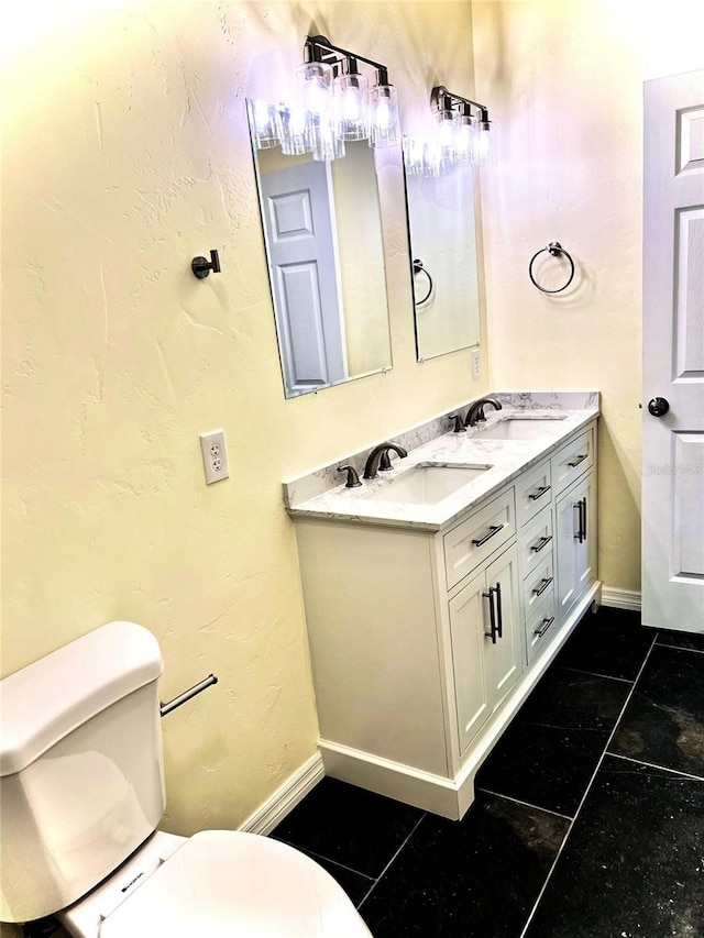 bathroom with vanity, toilet, and tile patterned floors