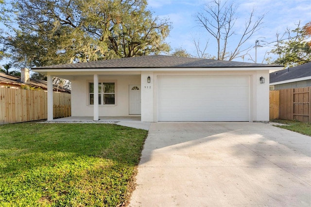 ranch-style house with a garage and a front lawn