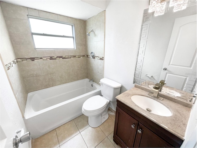 full bathroom featuring tiled shower / bath combo, vanity, toilet, and tile patterned flooring