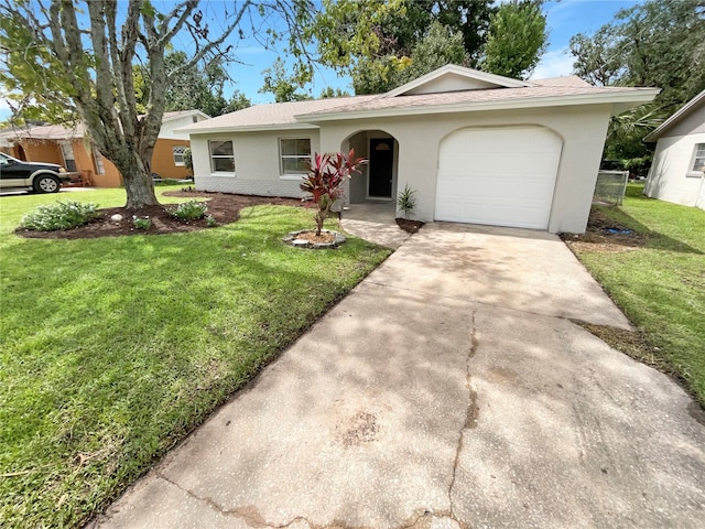 ranch-style house featuring a garage and a front lawn