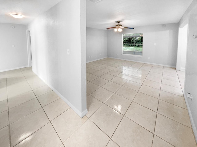 tiled empty room with ceiling fan