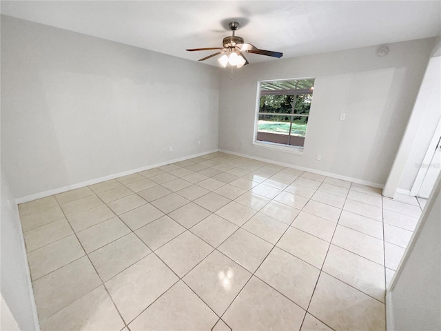 tiled empty room featuring ceiling fan