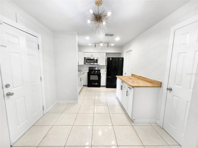 kitchen featuring black appliances, light tile patterned floors, butcher block countertops, and white cabinetry