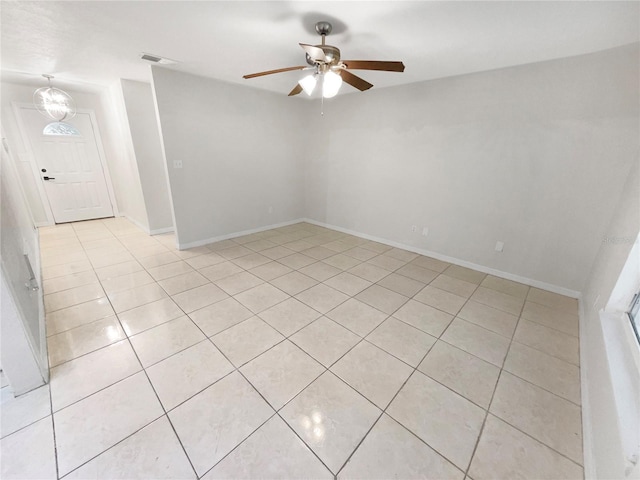 empty room featuring ceiling fan and light tile patterned floors