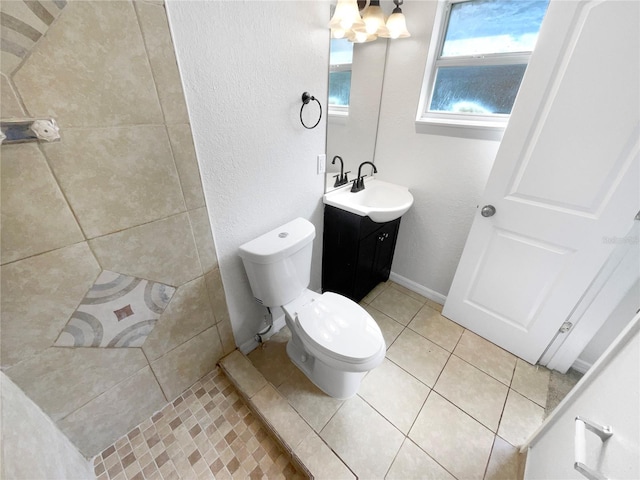 bathroom with vanity, toilet, tile patterned floors, and walk in shower