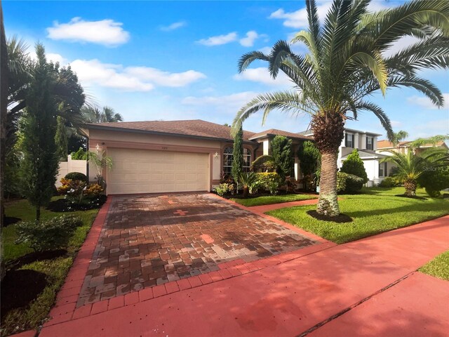 view of front facade with a garage and a front lawn