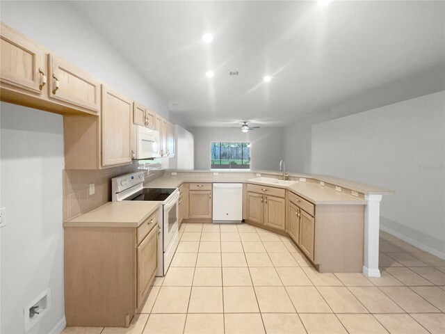 kitchen with white appliances, ceiling fan, kitchen peninsula, and sink