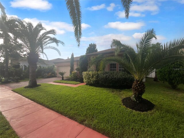 view of front of home featuring a garage and a front lawn