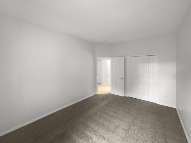 unfurnished bedroom featuring a closet and carpet floors