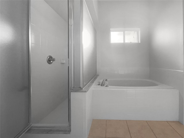 bathroom featuring plus walk in shower and tile patterned floors