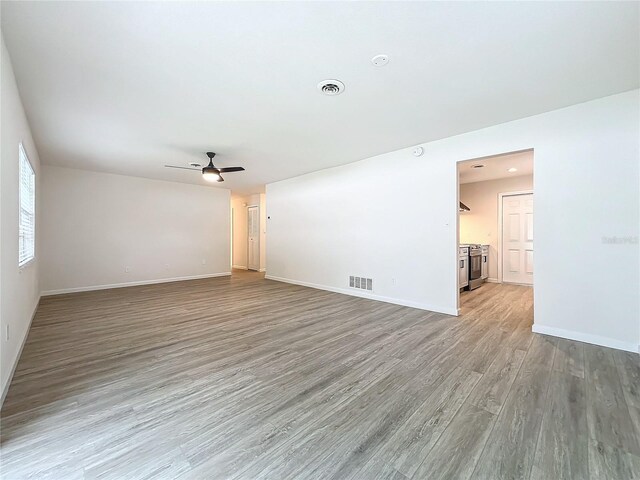 unfurnished room with ceiling fan and light hardwood / wood-style floors