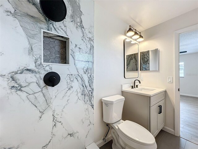 bathroom with vanity, toilet, and hardwood / wood-style floors