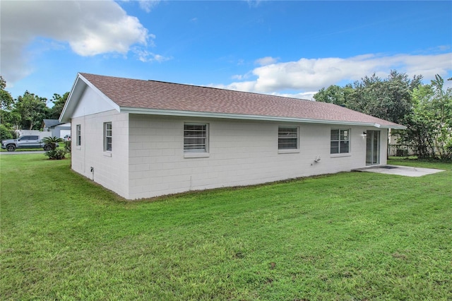 back of house with a lawn