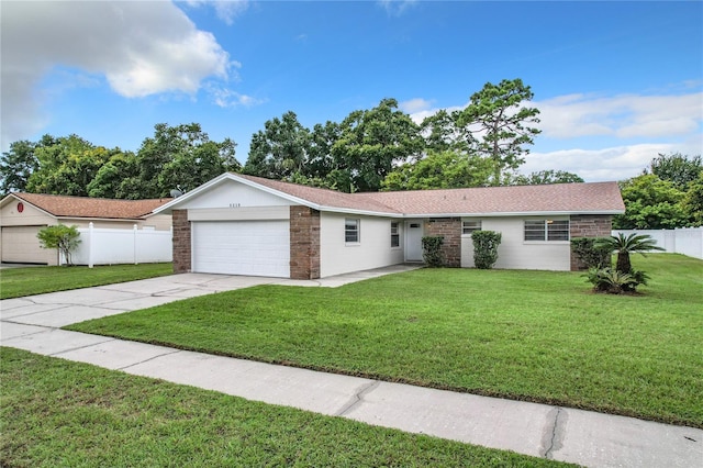 single story home featuring a front lawn and a garage