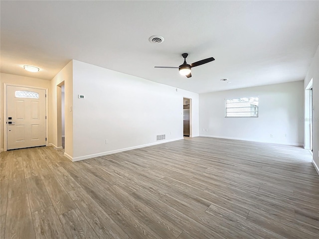 unfurnished living room with hardwood / wood-style floors and ceiling fan