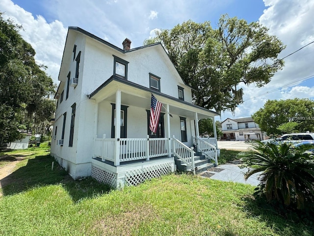 country-style home featuring a front yard and a porch