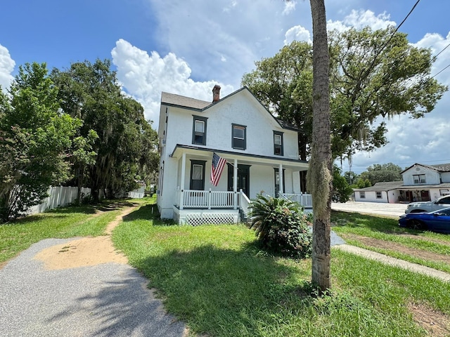 view of front of house featuring a front lawn and a porch