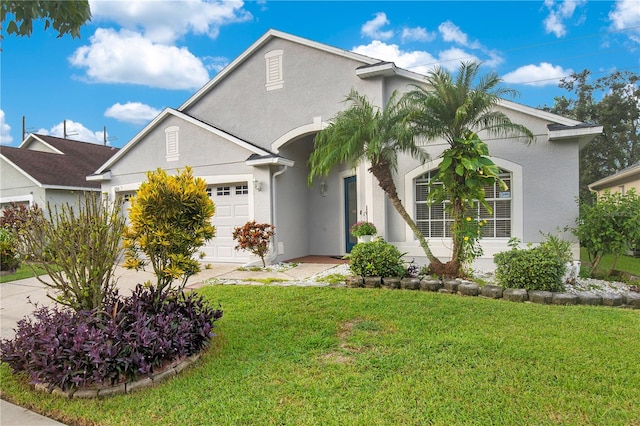 view of front of property featuring a garage and a front yard