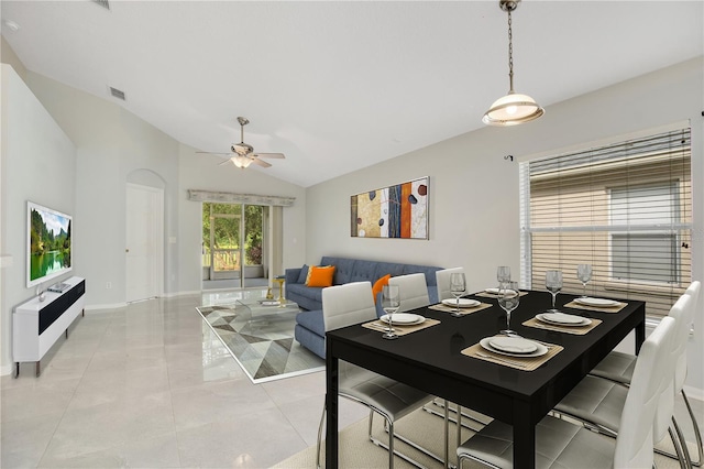 dining area with light tile patterned floors, lofted ceiling, and ceiling fan