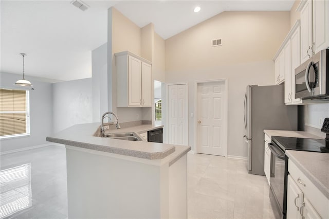 kitchen with appliances with stainless steel finishes, plenty of natural light, sink, and white cabinetry