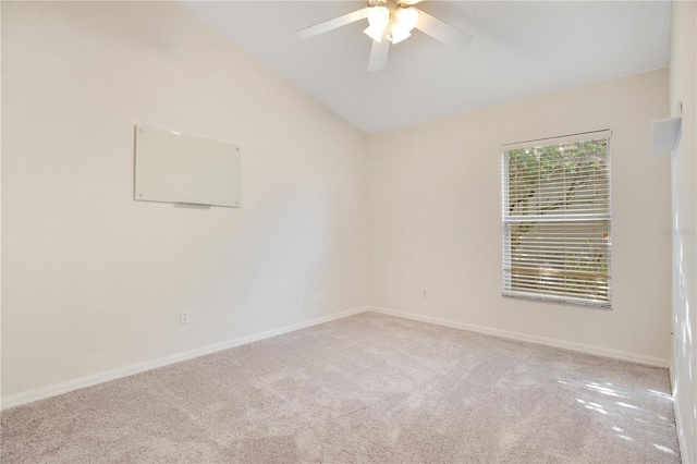 carpeted empty room featuring lofted ceiling and ceiling fan