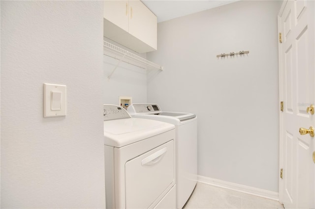 laundry room featuring cabinets and washer and dryer